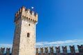 Tower with italian flag and stone defense wall with merlons of Scaligero Castle Castello di Sirmione Royalty Free Stock Photo