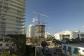 Tower lifting cranes at high residential apartment building construction site. Real estate development in Miami urban