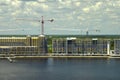 Tower lifting cranes at high residential apartment buildings construction site. Real estate development on sea shore Royalty Free Stock Photo