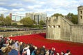 Tower of London with tourists looking at poppies