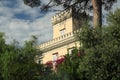 Tower of a Mediterranean villa with green park. Rich vegetation