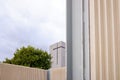 Tower of a modern church with a simple and minimalist design, seen from the outside, with a concrete cross