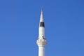 The tower of the mosque minaret against the background of the blue sky Royalty Free Stock Photo