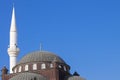 The tower of the mosque minaret against the background of the blue sky Royalty Free Stock Photo