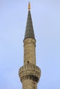 The tower of the mosque minaret against the background of the blue sky. Royalty Free Stock Photo