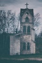 The tower of an old abandoned Church against a cloudy stormy sky. Beautiful background for greeting card or wallpaper on Halloween Royalty Free Stock Photo