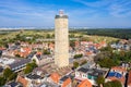 The tower of old Brandaris lighthouse among historical houses around the central square of West-Terschelling town. Terschelling