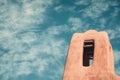 Tower of an old historic adobe church in New Mexico with a painterly sky Royalty Free Stock Photo