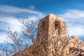 Tower of an old historic adobe church in New Mexico with a painterly sky Royalty Free Stock Photo