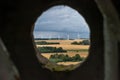 Tower through one of the view holes. Here wind turbines in the background
