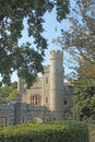 The Tower and Orangery of Whitstable Castle nestled behind trees and bushes