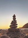 Tower of pebble in the Kabak Valley beach and sunset Royalty Free Stock Photo