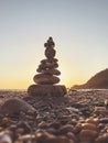 Tower of pebble in the Kabak Valley beach and sunset Royalty Free Stock Photo