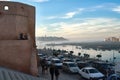 Tower, pedestrians and vehicles on the streets of Morocco