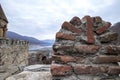 Tower and protective wall of the fortified Ananuri castle on the background of the Zhinvali reservoir Royalty Free Stock Photo