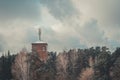 Tower-repeater of mobile communication and the Internet on an abandoned water building in the forest. Selective focus Royalty Free Stock Photo