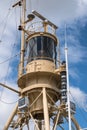 tower of a rescue ship with radar, lights and communication equipment against the blue sky with clouds, vertical Royalty Free Stock Photo