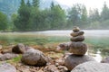 Tower of rocks by the beautiful calm river of Soca