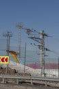 The tower of the ski lift against the background of the blue sky behind the fence. Royalty Free Stock Photo