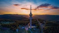 Tower Snezhanka in Rhodope mountains with fog, forest, sunbeams and sunny clouds. Panorama, top view Royalty Free Stock Photo