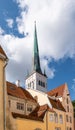 Tower of St Olaf\'s Church behind traditional buildings in old town of Tallinn, Estonia. Royalty Free Stock Photo