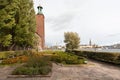 Tower of Stockholm Stadshuset built in 1923 and tall trees around. Examples of architecture of Sweden