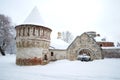 Tower and stone carved gate of the Fyodorovsky town cloudy February day. Winter in Tsarskoye Selo, Russia