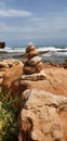 Tower of stones on the background of the sea. Stone tower balance. Royalty Free Stock Photo