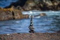 Tower of stones on sea beach background. Relaxing in the tropical beach, with stack of stones. Royalty Free Stock Photo