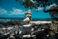 Tower of stones on sea beach background. Relaxing in the tropical beach, with stack of stones. Royalty Free Stock Photo