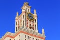 Tower with thermometer of Lomonosov Moscow State University MSU against blue sky in sunny summer evening Royalty Free Stock Photo
