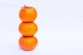 Tower of Three stacked mini pumpkins with fall maple leaf on the top on the white background isolated. Autumn holiday, harvest, He