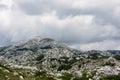 Tower on the top of Sveti Jure mountain and cumulus storm clouds