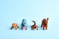 Tower of toy dinosaurus on blue background. Funny prehistoric poster. Copy space