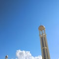 Tower of Tranquility: Majestic Mosque Minaret Against a Blue Sky
