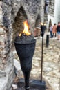 Tower wall highlighted by pair of iron torch in Tallinn