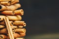 Tower of whole sticks of fragrant cinnamon on a wooden rural table. copyspace. composition of seasoning and slide flavoring