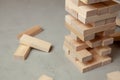 Tower of wooden blocks on gray background. Board game for the whole family or party. Concept of building business or building team