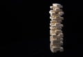 A tower of wooden blocks toy with a black background. The concept of learning and development. Royalty Free Stock Photo