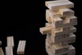 Tower from wooden blocks toy with black background. Learning and development concept. Royalty Free Stock Photo