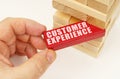 From the tower with wooden planks, they take out a red plaque with the inscription - Customer Experience Royalty Free Stock Photo