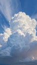 Towering clouds swirl in shades of white and gray against a vibrant blue backdrop, creating a dramatic display that Royalty Free Stock Photo
