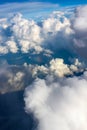 Towering cloudscape from airplane view with a little rainbow right in the middle