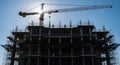 Towering construction crane overseeing a high-rise building under construction Royalty Free Stock Photo