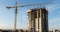 Towering construction crane overseeing a skyscraper under development Royalty Free Stock Photo