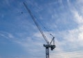 Towering crane - soft blue sky with wispy clouds - cables and pulleys - construction Royalty Free Stock Photo