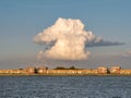 Towering cumulonimbus cloud over apartments on IJsselmeerdijk in Lelystad, Netherlands