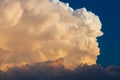 Towering cumulonimbus thunderstorm cloud with blue sky in the ba