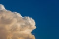 Towering cumulonimbus thunderstorm cloud with blue sky in the ba