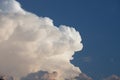 Towering cumulonimbus thunderstorm cloud with blue sky in the ba